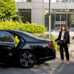 businessman-female-chauffeur-near-car-outdoors